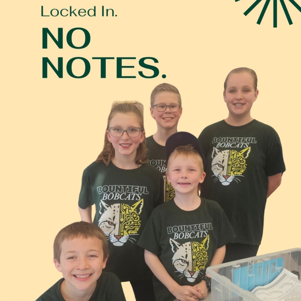 Five students in matching dark green Bountiful Bobcats shirts pose behind a table with VEX parts organizers and a large plastic bin. Text reads “Locked In. NO NOTES.” Bountiful Elementary logo in the bottom left.