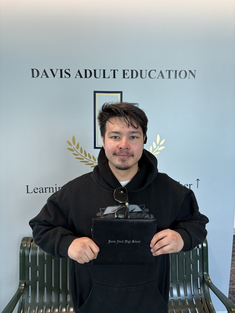 a picture of Diego Anguiano holding his diploma