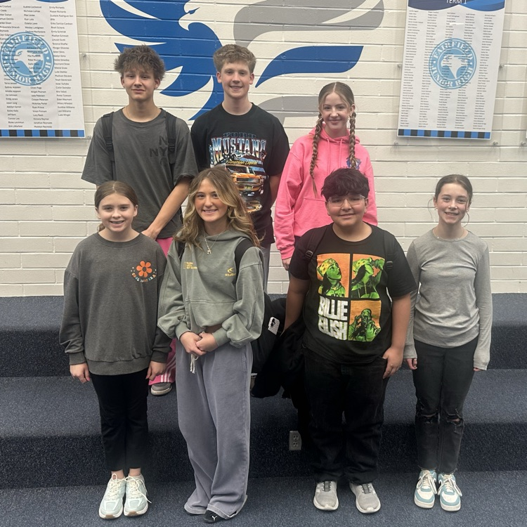 7 students of the month posing for a photo.