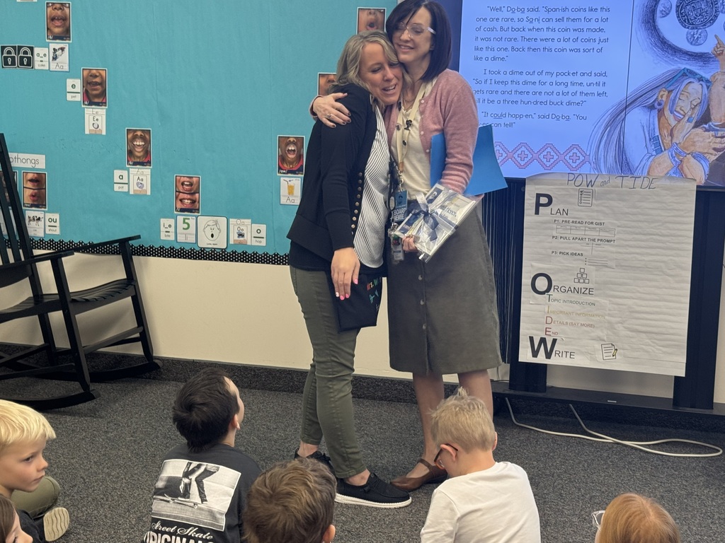 teacher receiving award from school board member