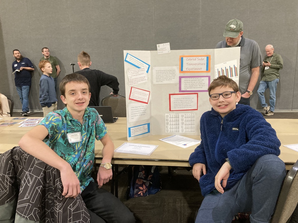 Student in front of science poster