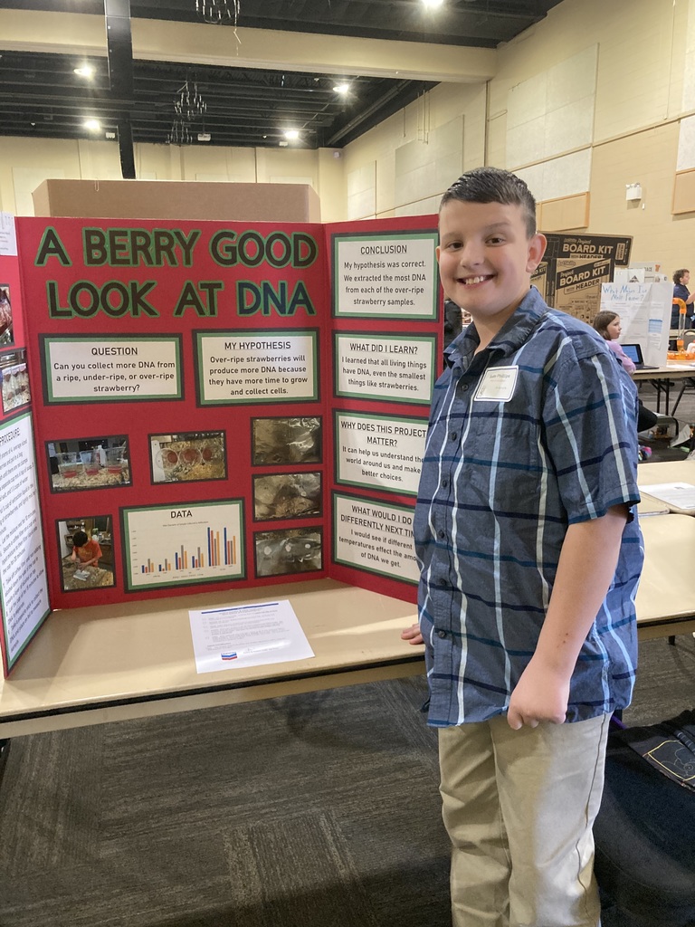 Student in front of science poster