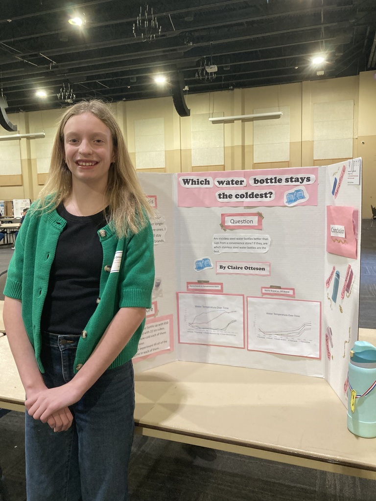 Student in front of science poster