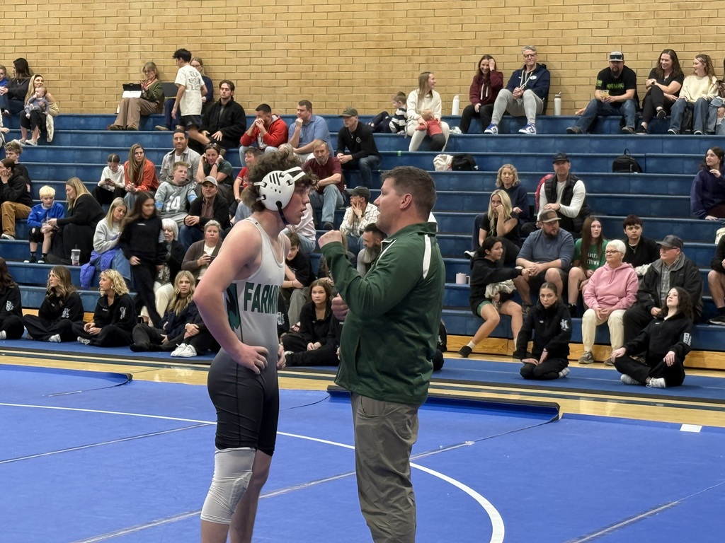 Wrestler speaking with his coach. 
