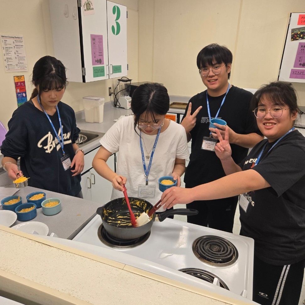 Taiwanese exchange students learning to cook mac and cheese
