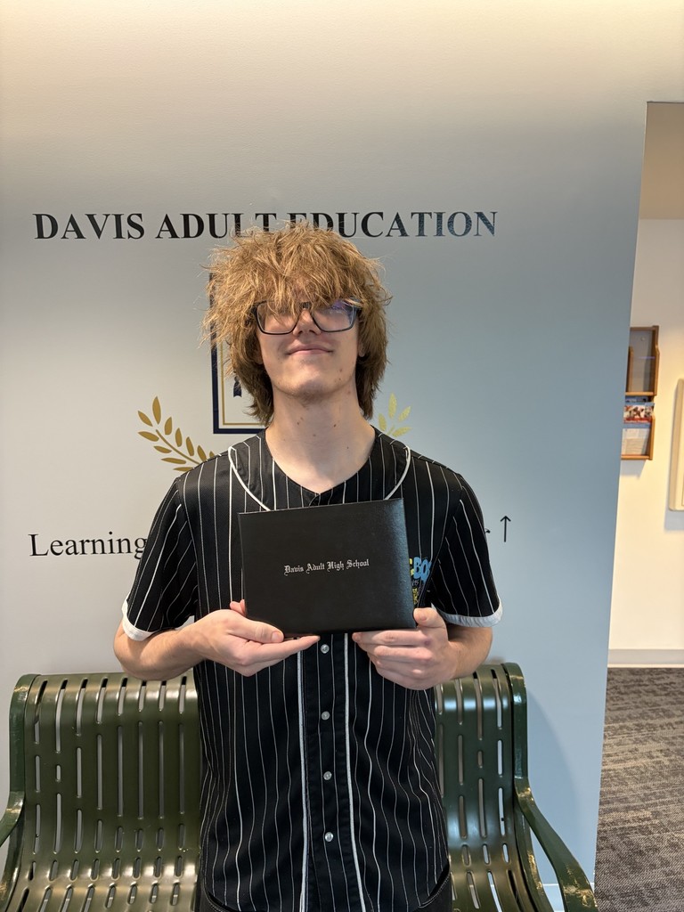 a picture of Dylan Ridenour holding his diploma