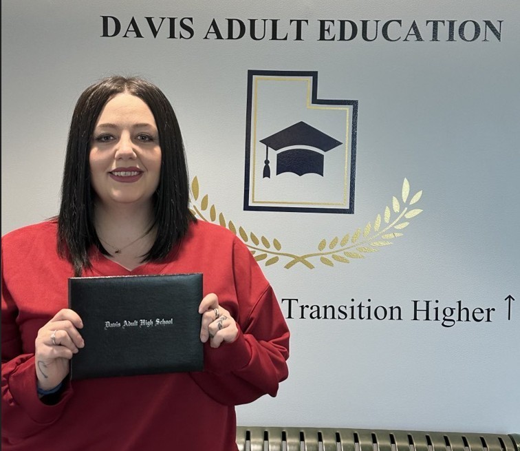 a picture of Autum Mercer holding her diploma