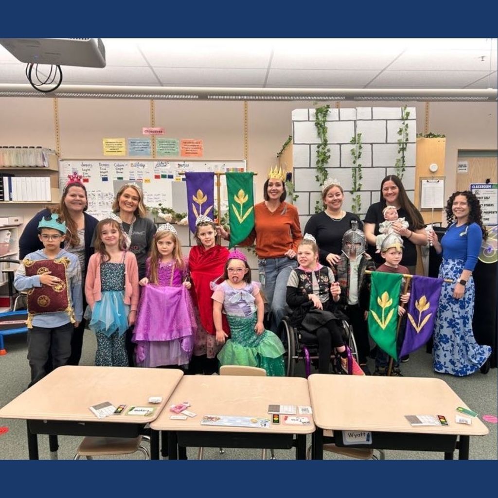 Students pose for a picture dressed and knights and princesses.