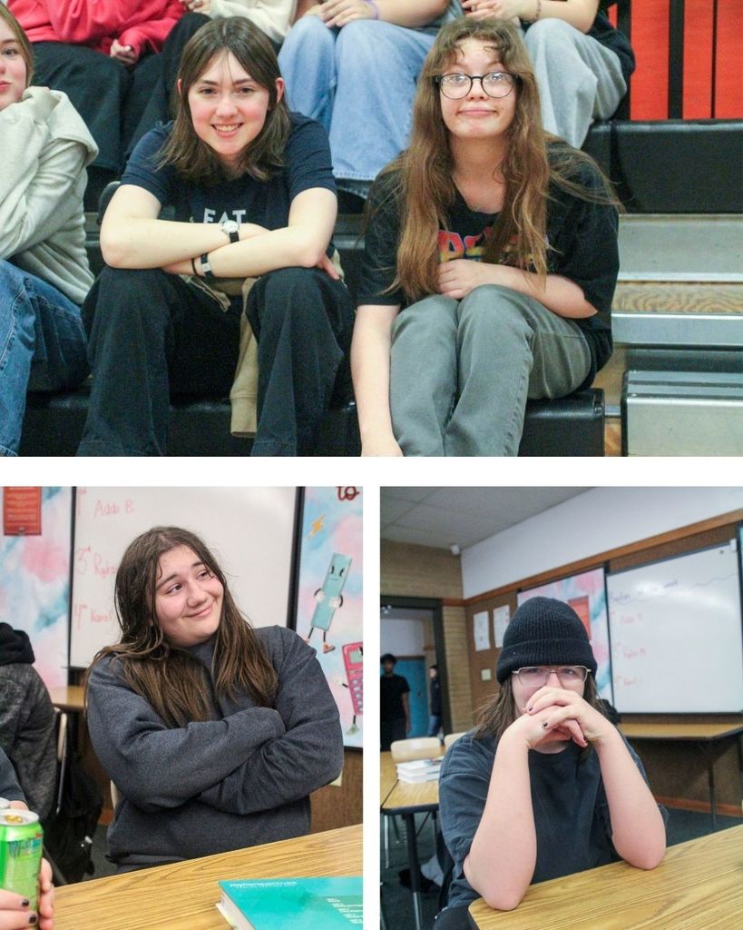 Students sitting at desks looking at the camera