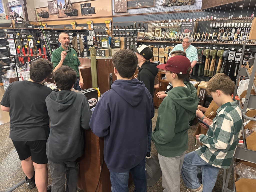 Students learning about fishing gear from a Cabela’s employee. 