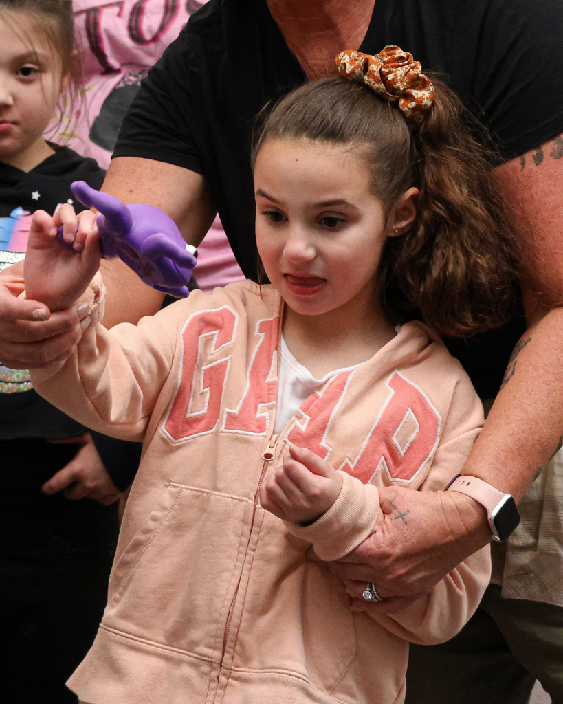 A student throws a rubber frog.
