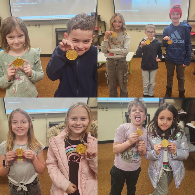 Students showing off their gold medals they won during STEM Olympics 