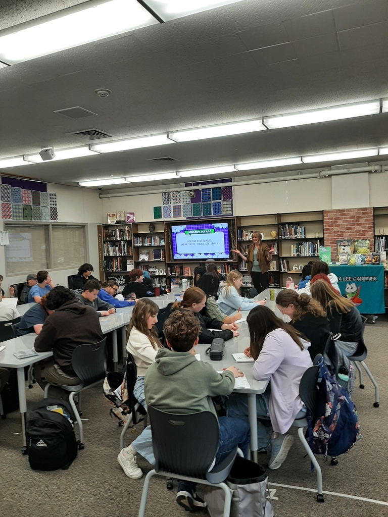 Students in the library receiving instruction