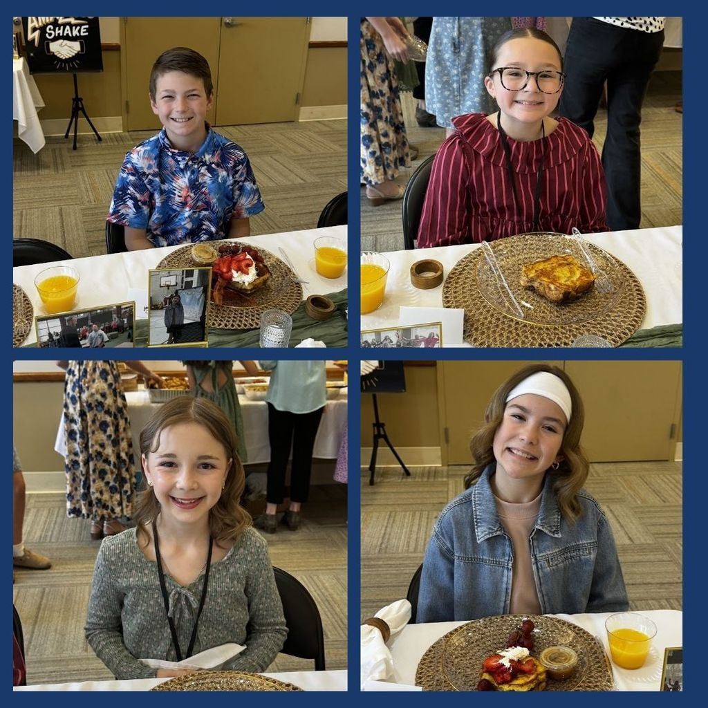 Students eating food and having a discussion at a round table with city leaders.