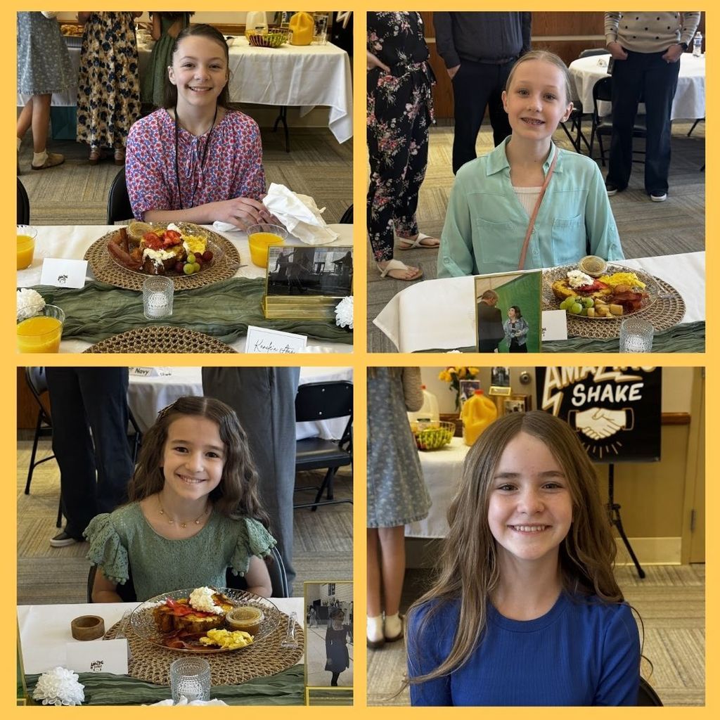 Students eating food and having a discussion at a round table with city leaders.