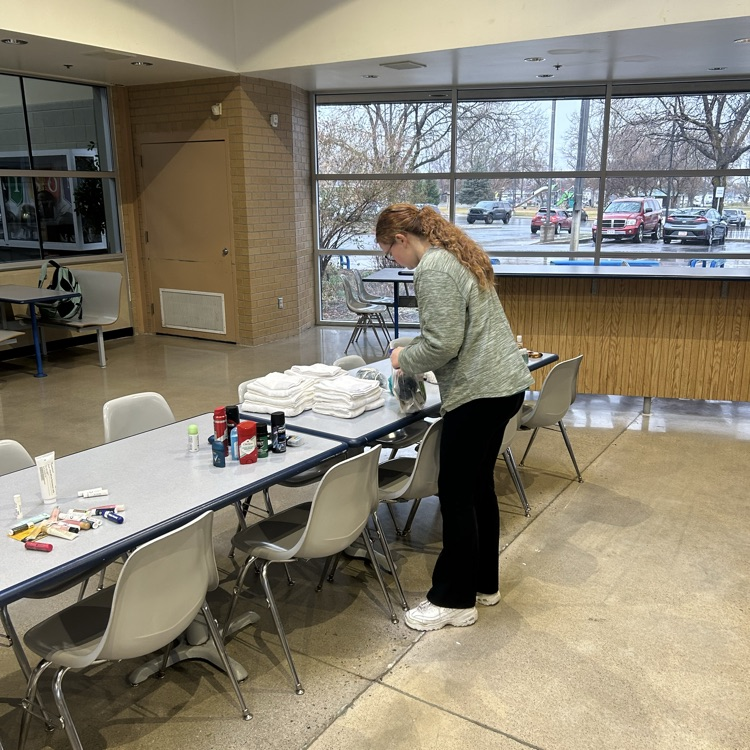service club putting together hygiene kits