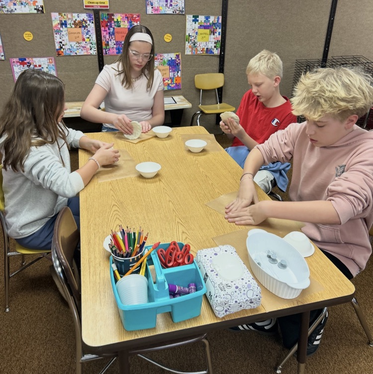 6th graders working on a pottery project 