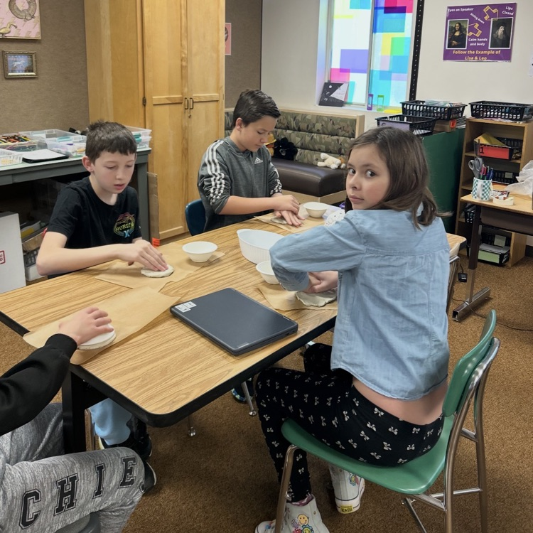 6th graders working on a pottery project 