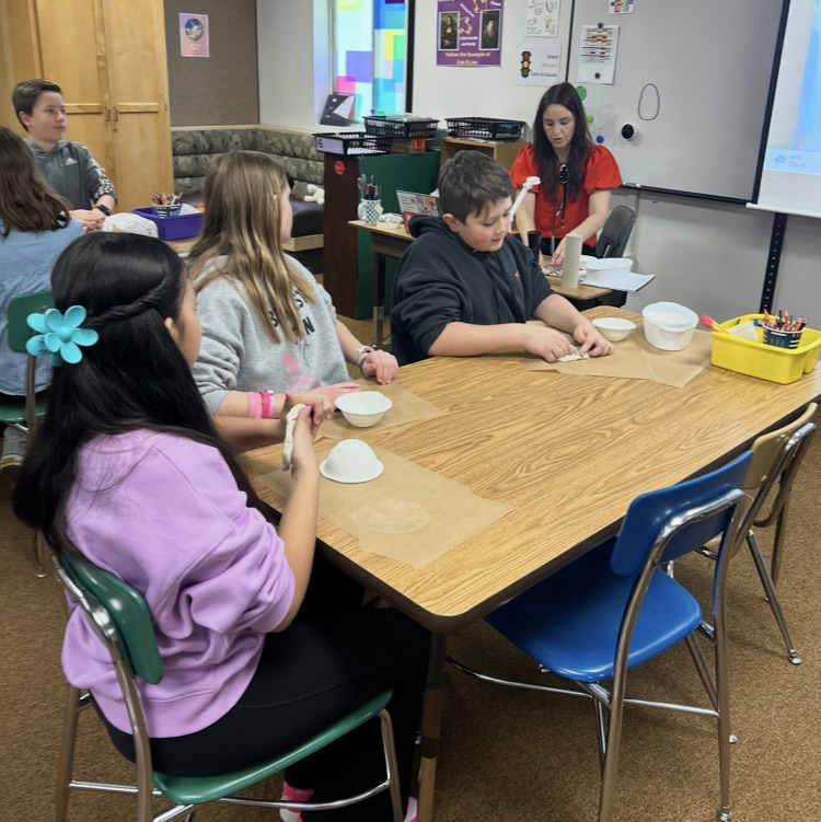 6th graders working on a pottery project 