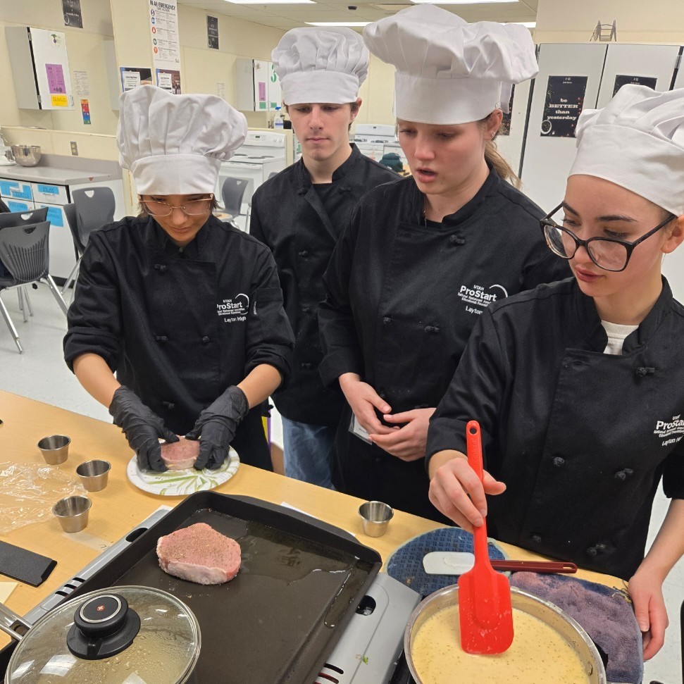 ProStart students cooking porkchops and gravy