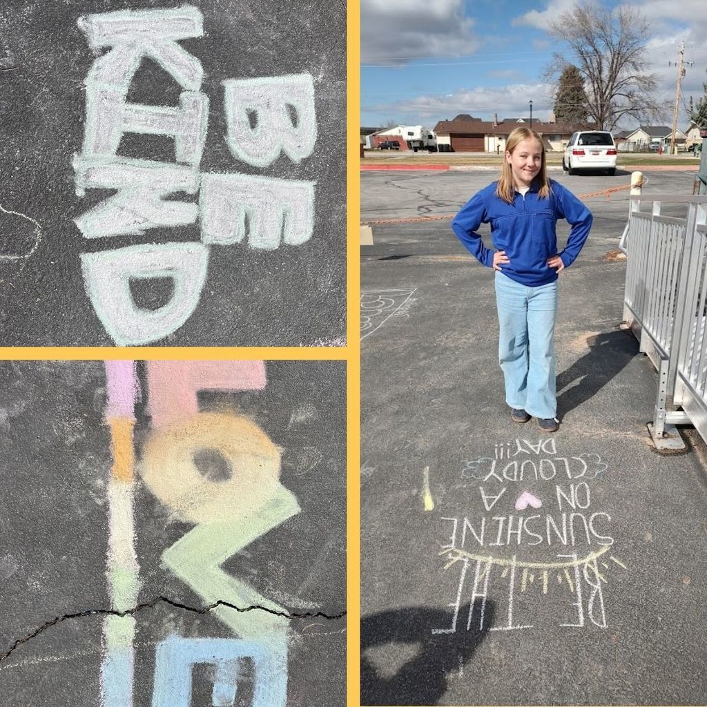 Chalk on the blacktop with: Be Kind and Love and Be the Sunshine on a Cloudy Day and a students posing next to the chalk art.