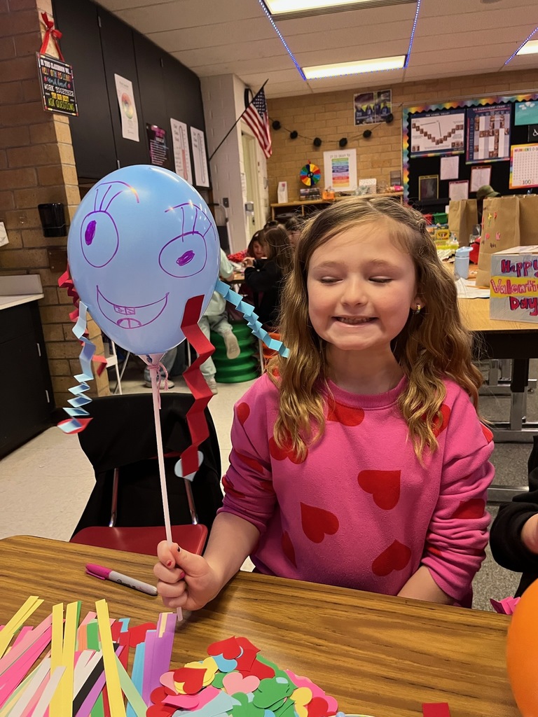 Student holding her art project