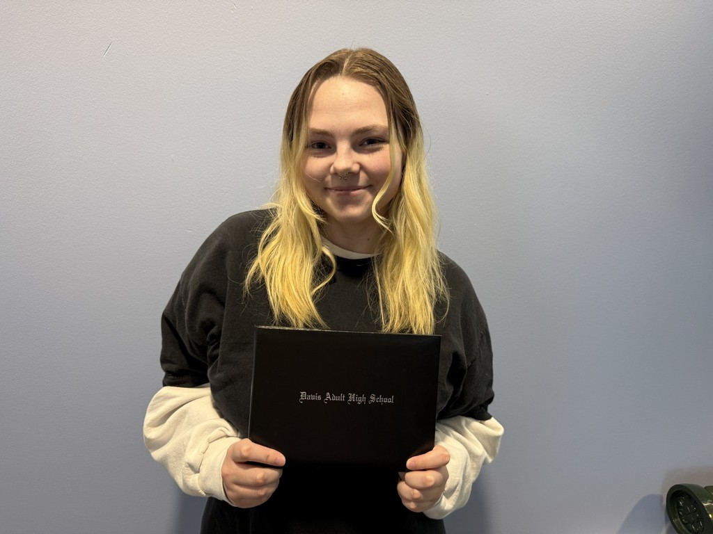 KJ Young holding her diploma