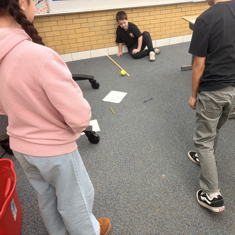 4th grade students conducting an experiment on energy transfer. 