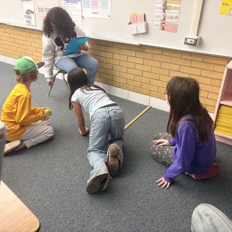 4th grade students conducting an experiment on energy transfer. 