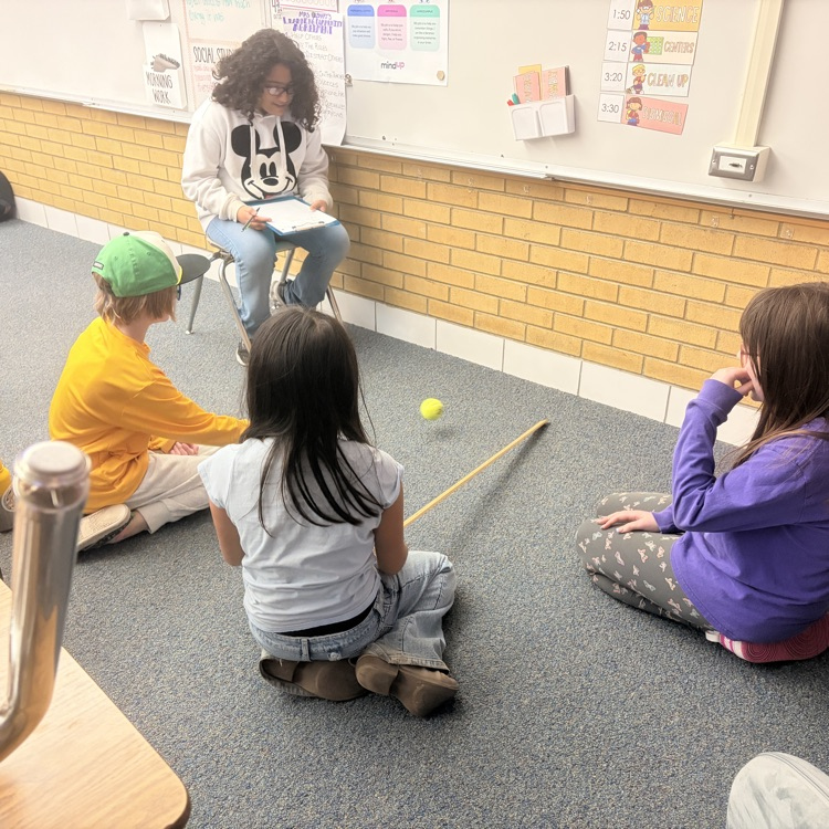 4th grade students conducting an experiment on energy transfer. 