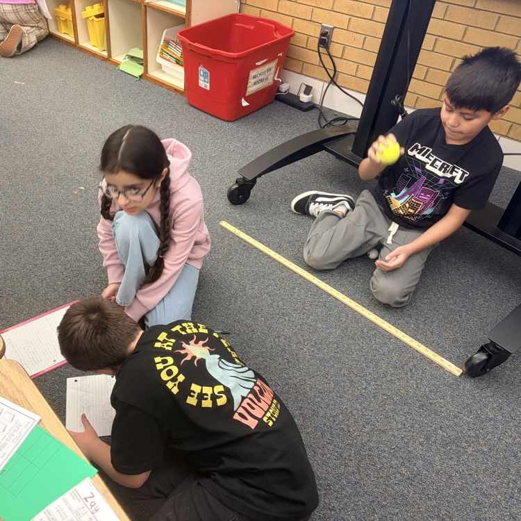 4th grade students conducting an experiment on energy transfer. 