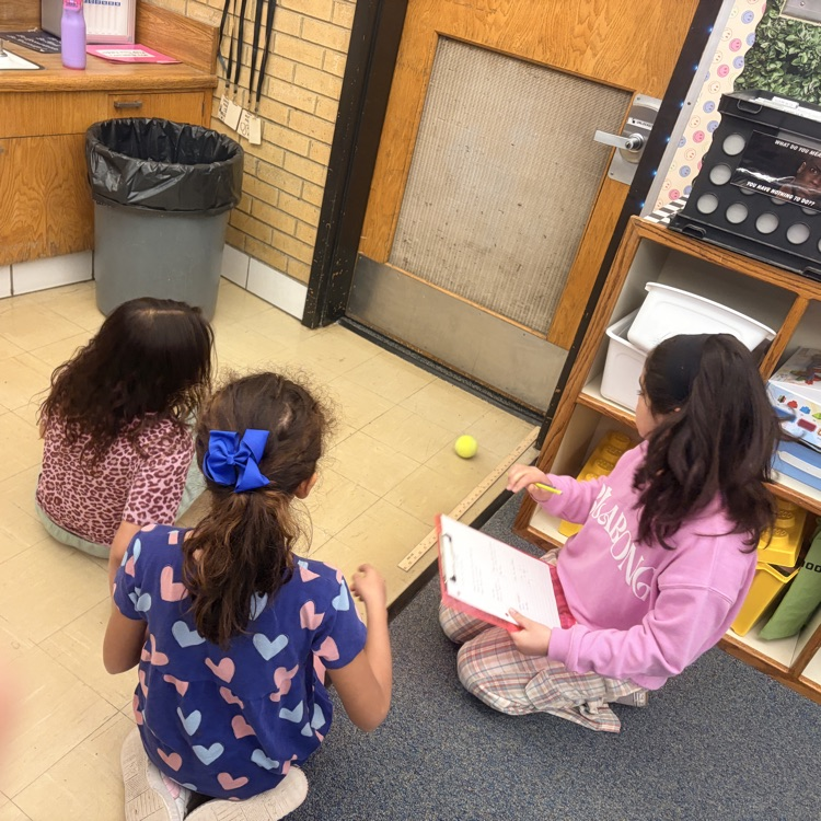 4th grade students conducting an experiment on energy transfer. 