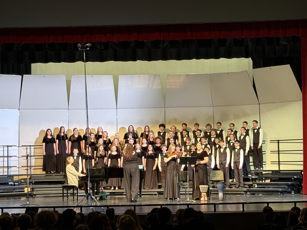 Choir singing and playing the violin. 