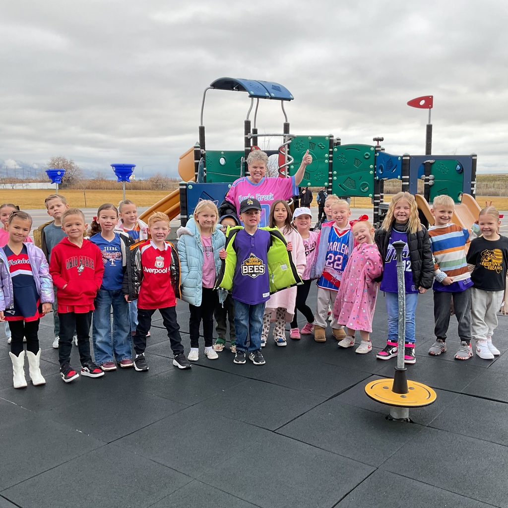 students photographed showing of their team apparel for Friendship & Inclusion Week.