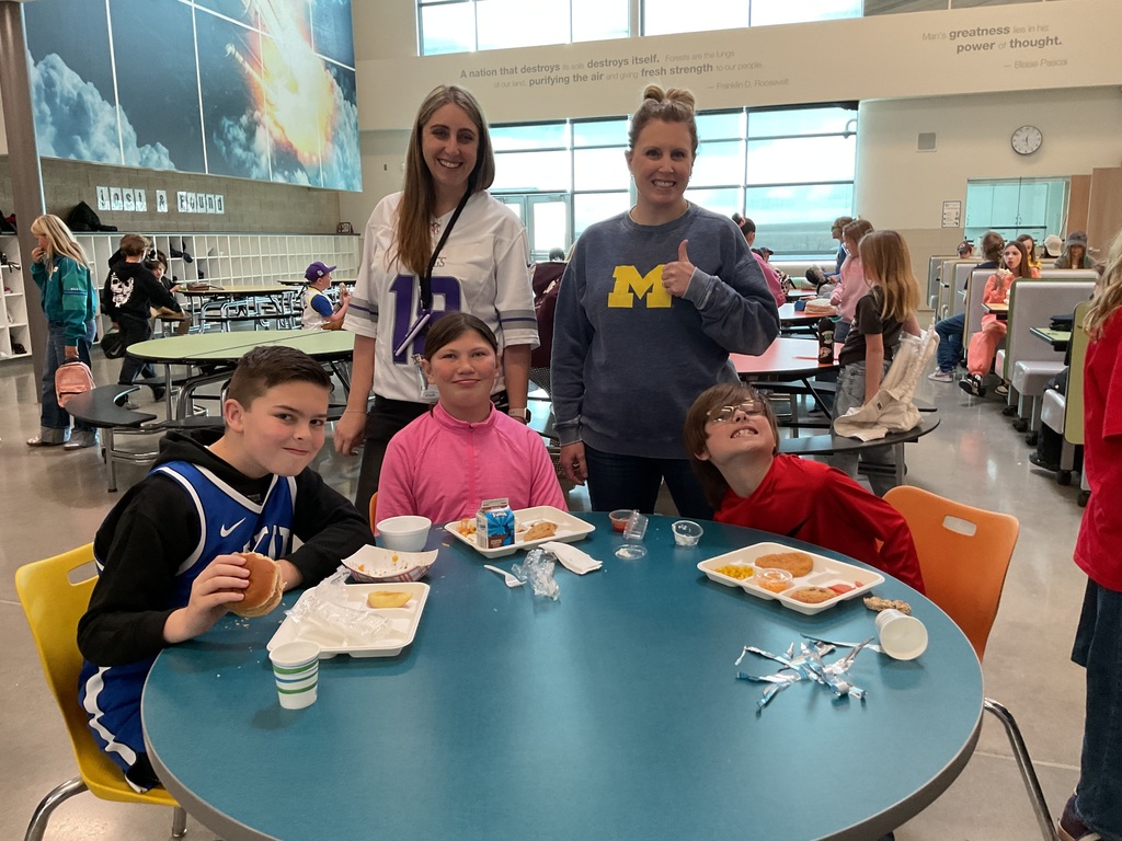 students photographed showing of their team apparel for Friendship & Inclusion Week.