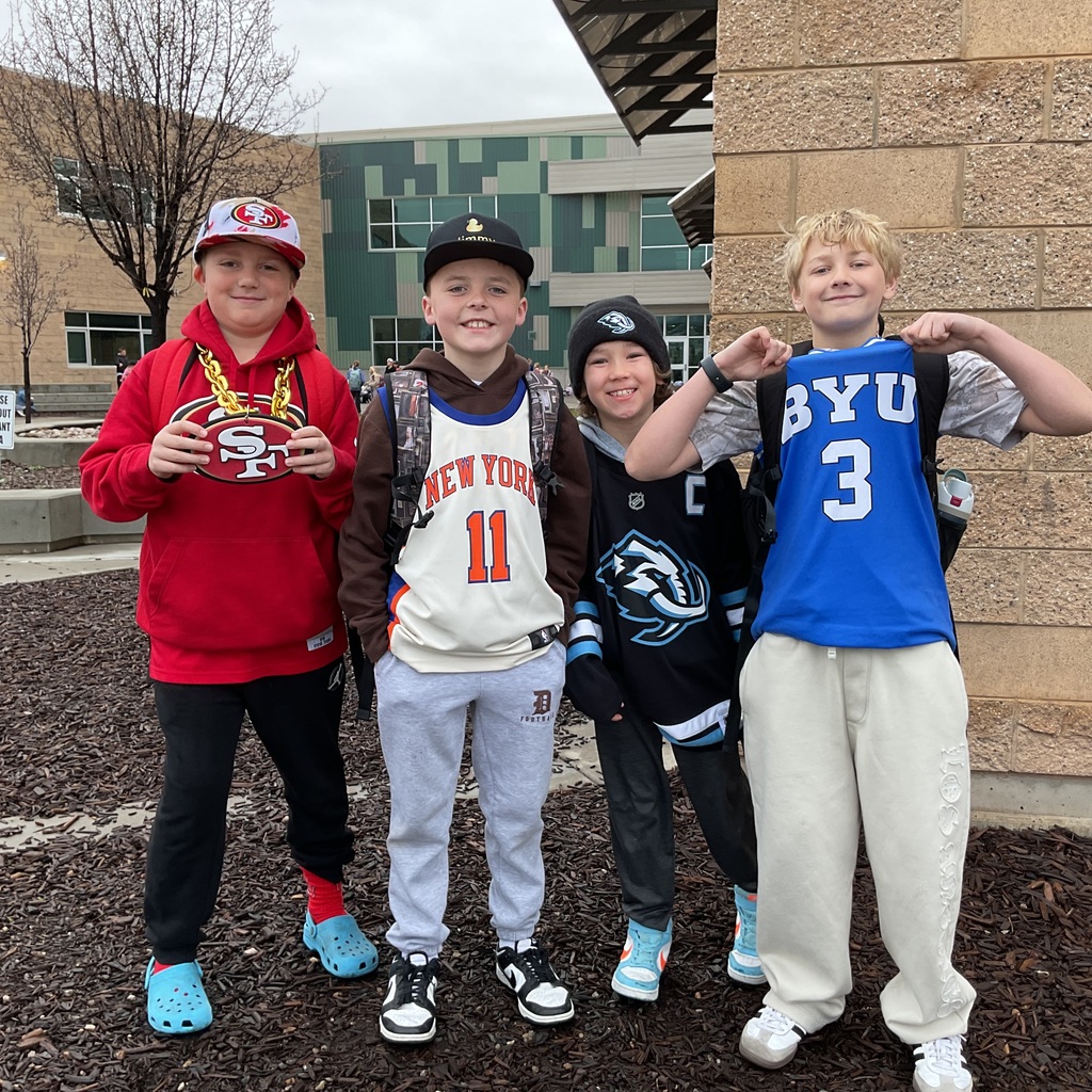 students photographed showing of their team apparel for Friendship & Inclusion Week.