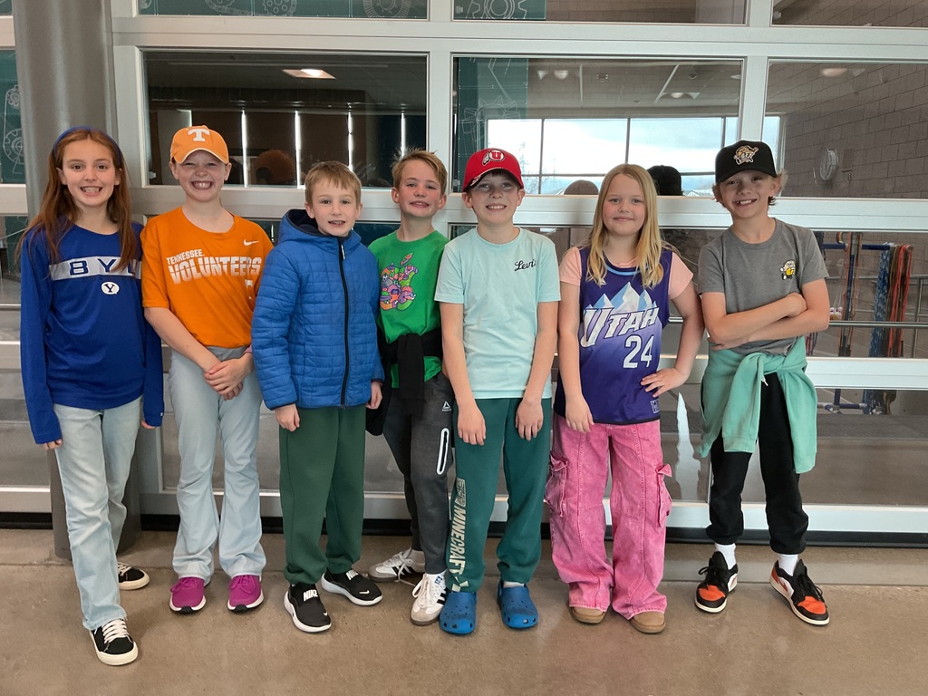 students photographed showing of their team apparel for Friendship & Inclusion Week.