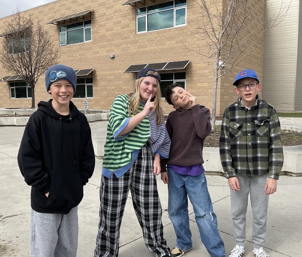 students photographed showing of their team apparel for Friendship & Inclusion Week.