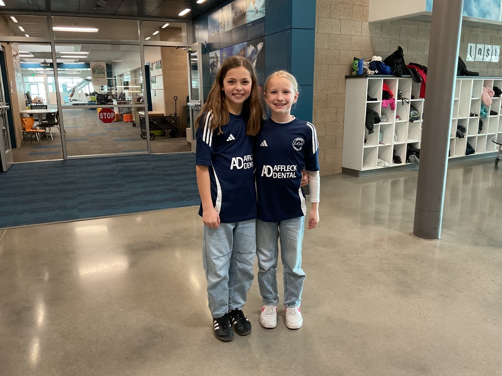 students photographed showing of their team apparel for Friendship & Inclusion Week.