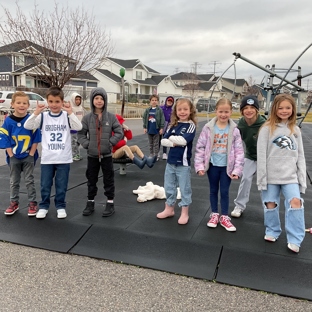 students photographed showing of their team apparel for Friendship & Inclusion Week.