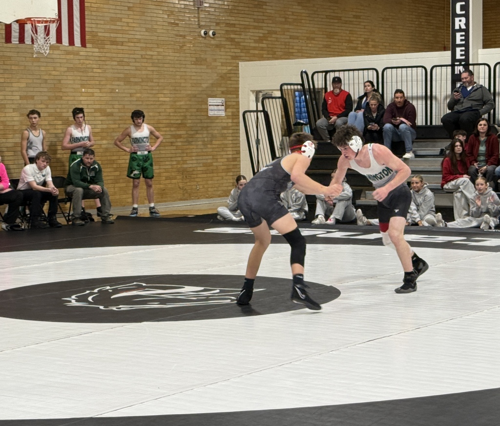 Two student athletes in the middle of a wrestling round. 