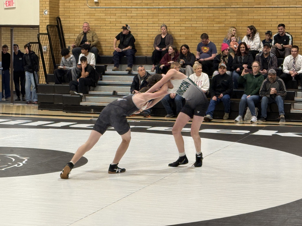 FJH wrestler standing up with Millcreek Jr wrestler. 