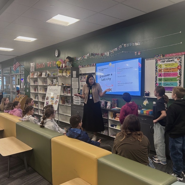 women in black dress presenting to students