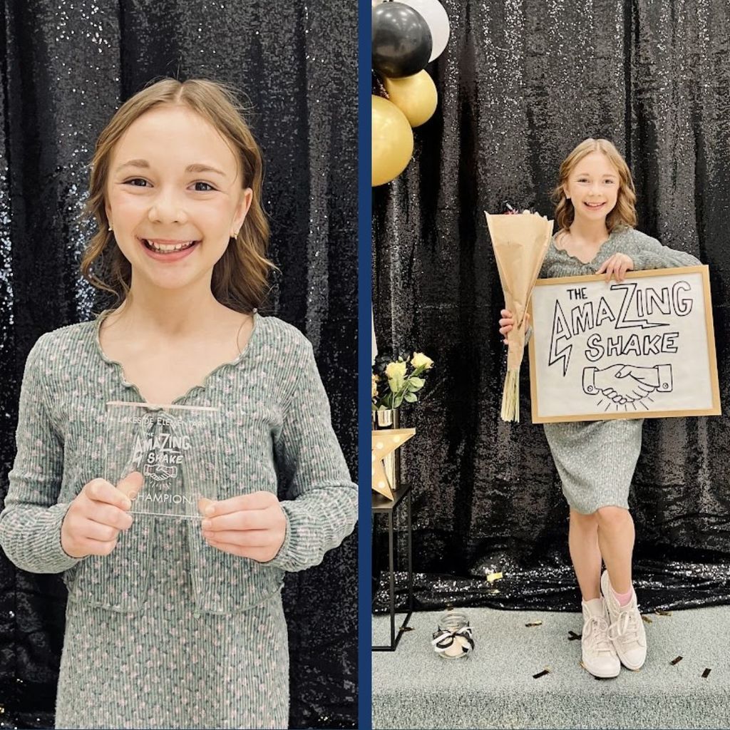 Student holds an award and chalk board as winner of the Amazing Shake.