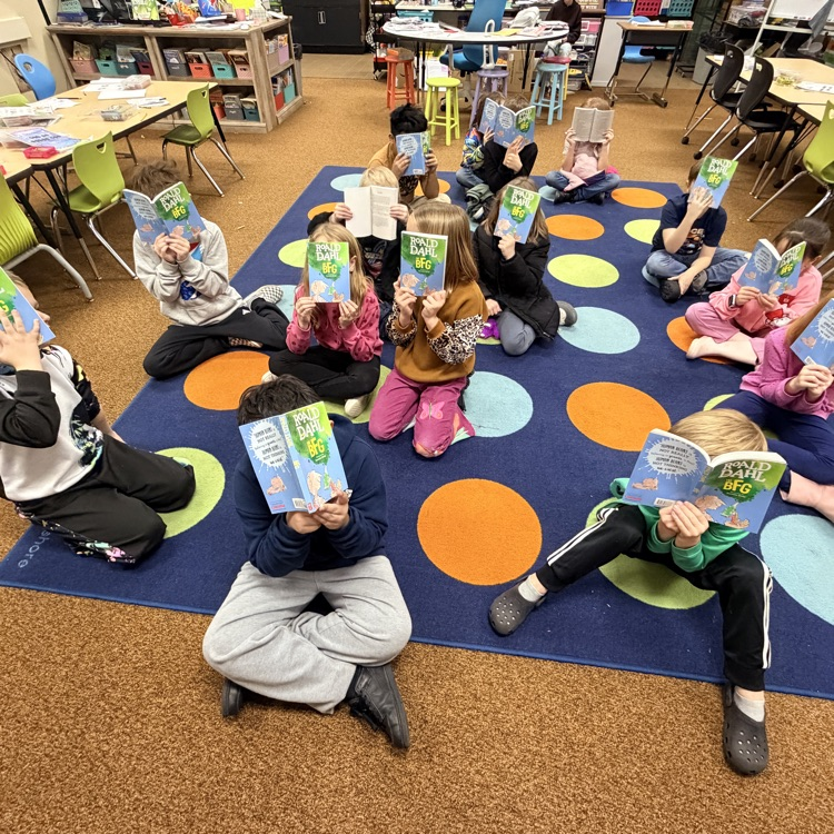 students with their book of the month 