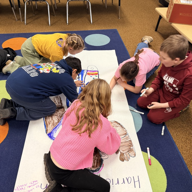 students creating a poster based on what they learned about Harriet Tubman