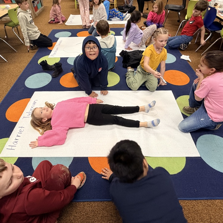 students creating a poster based on what they learned about important people from the Civil War era