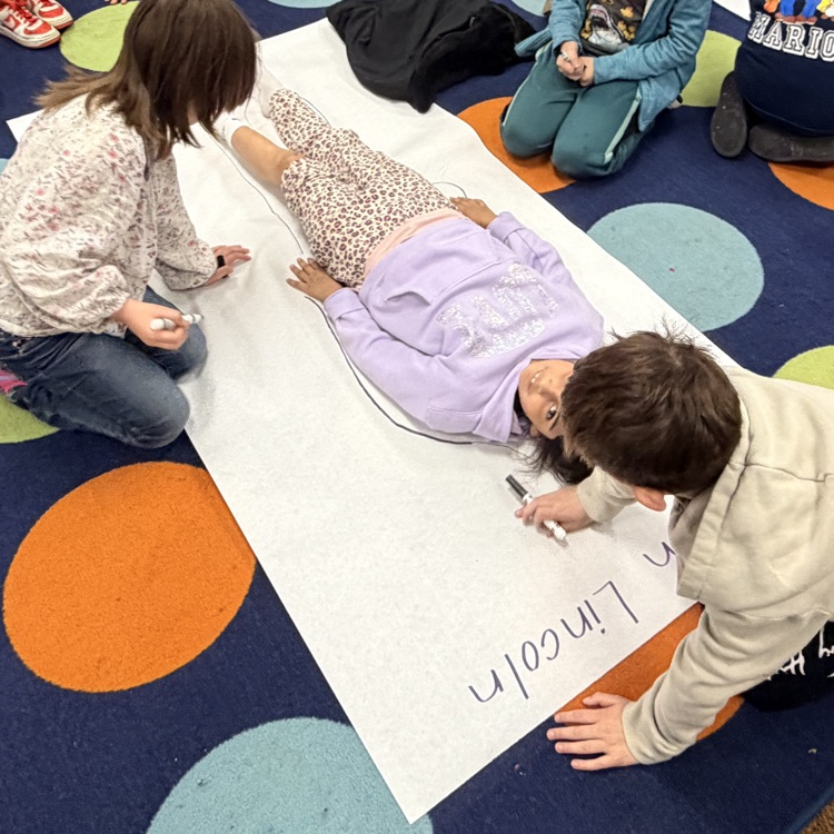 students creating a poster based on what they learned about Abraham Lincoln