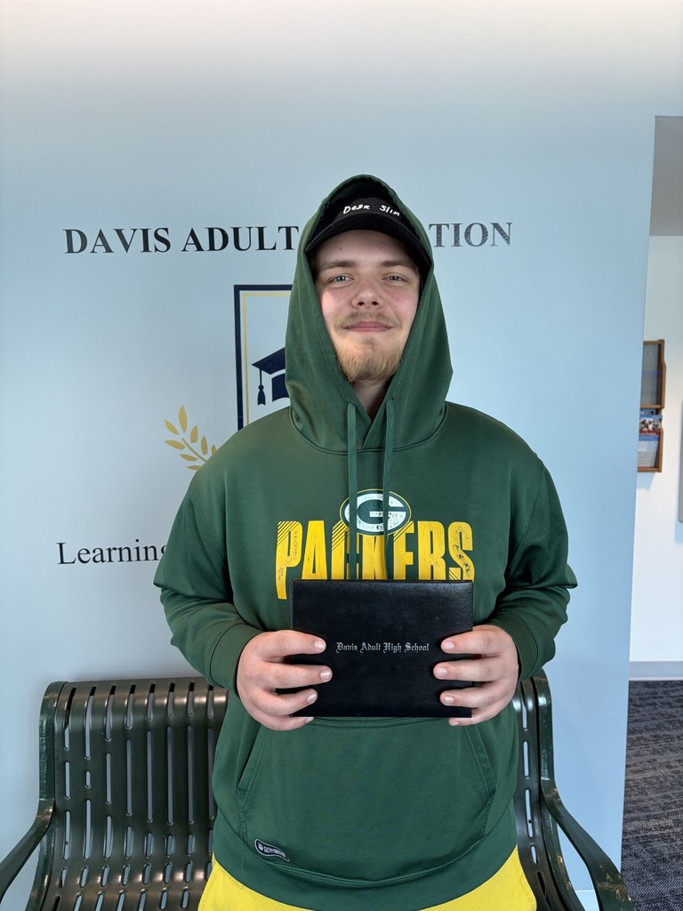 Michael Jones holding his adult high school diploma