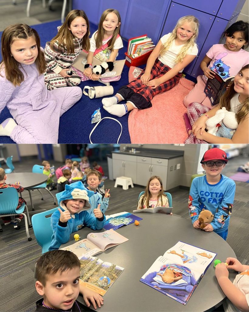 A small group of elementary students sit together on the classroom floor with books, stuffed animals, and blankets as they read and share stories during a Reading Week buddy activity.